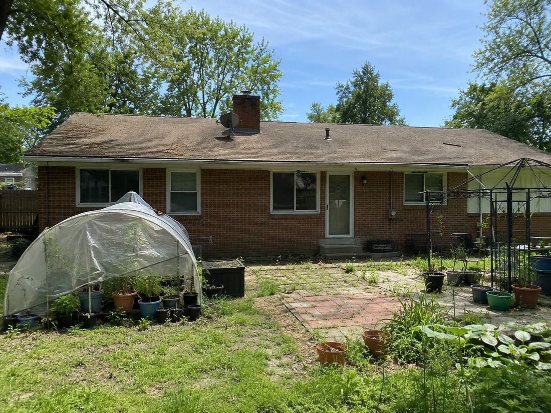 A brick ranch with a backyard garden