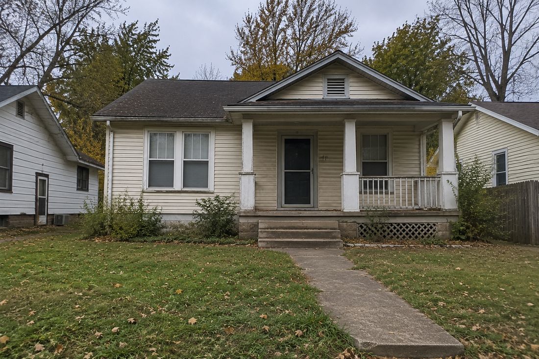 A craftsman bungalow with a covered front porch