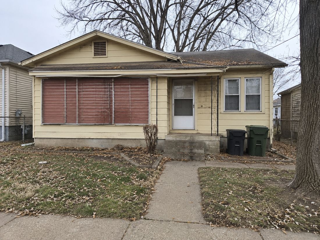 A small bungalow with an enclosed front porch