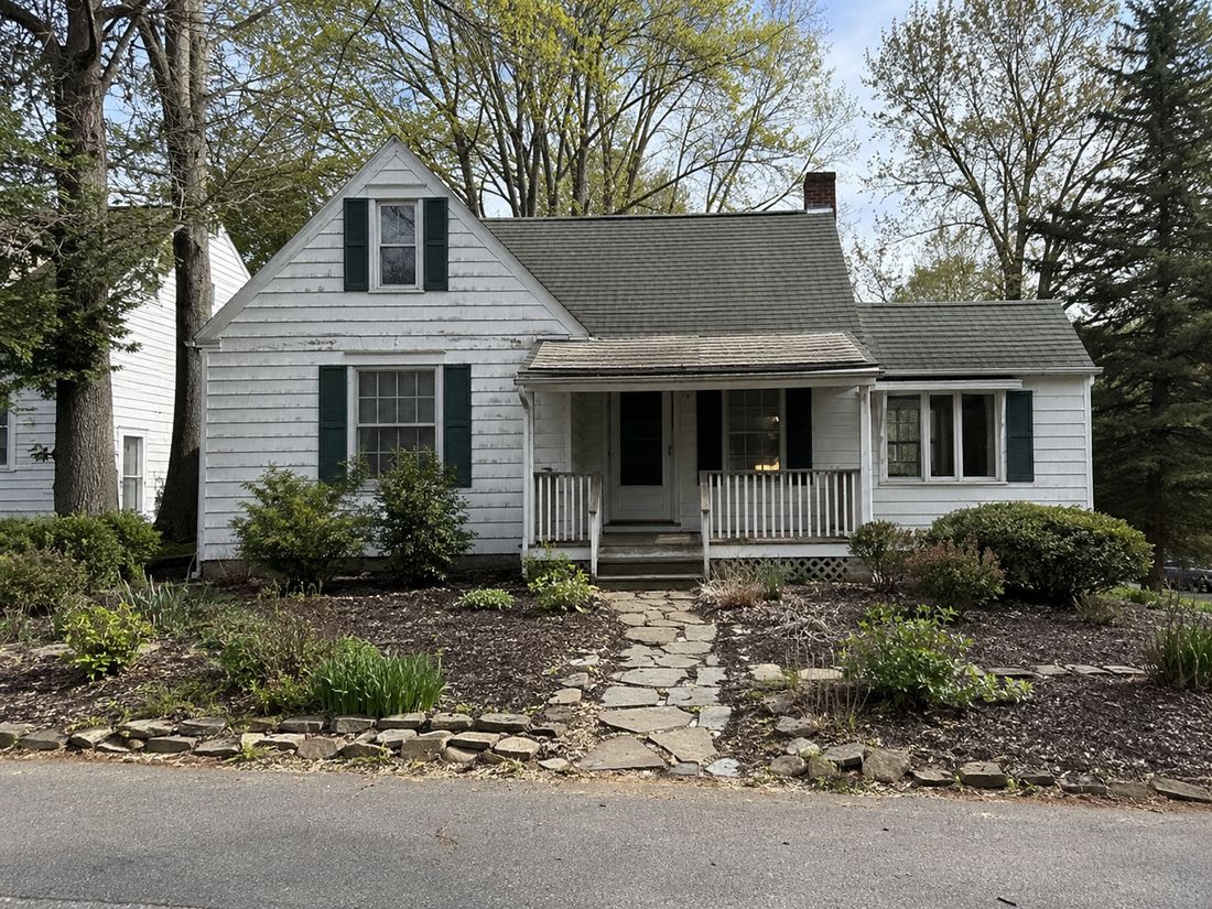 A small cottage with a stone path